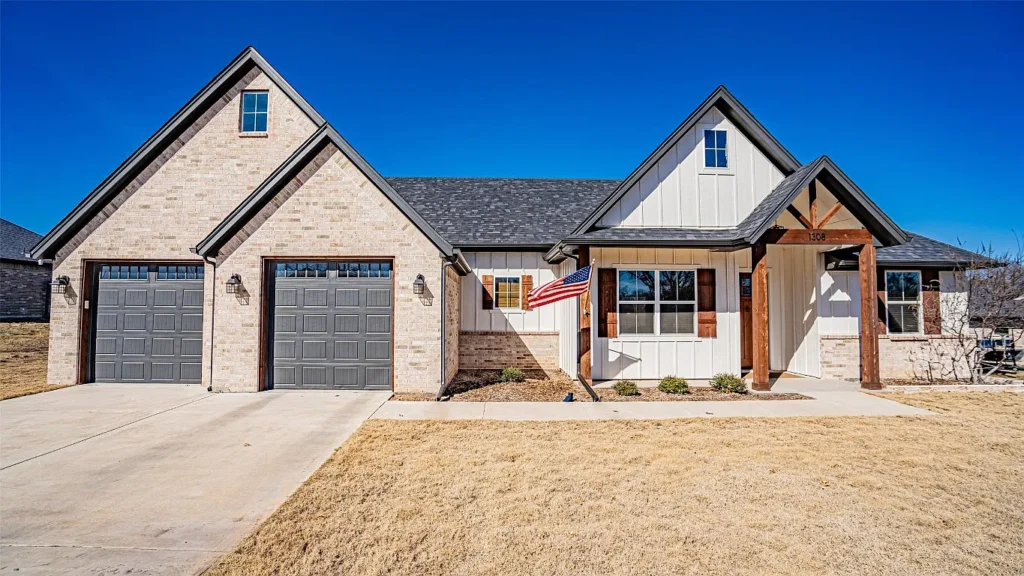 Stone and board-and-batten farmhouse with 3-car garage